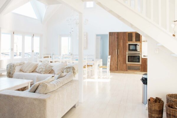 Spacious modern white interior of a modern home with bright natural light.